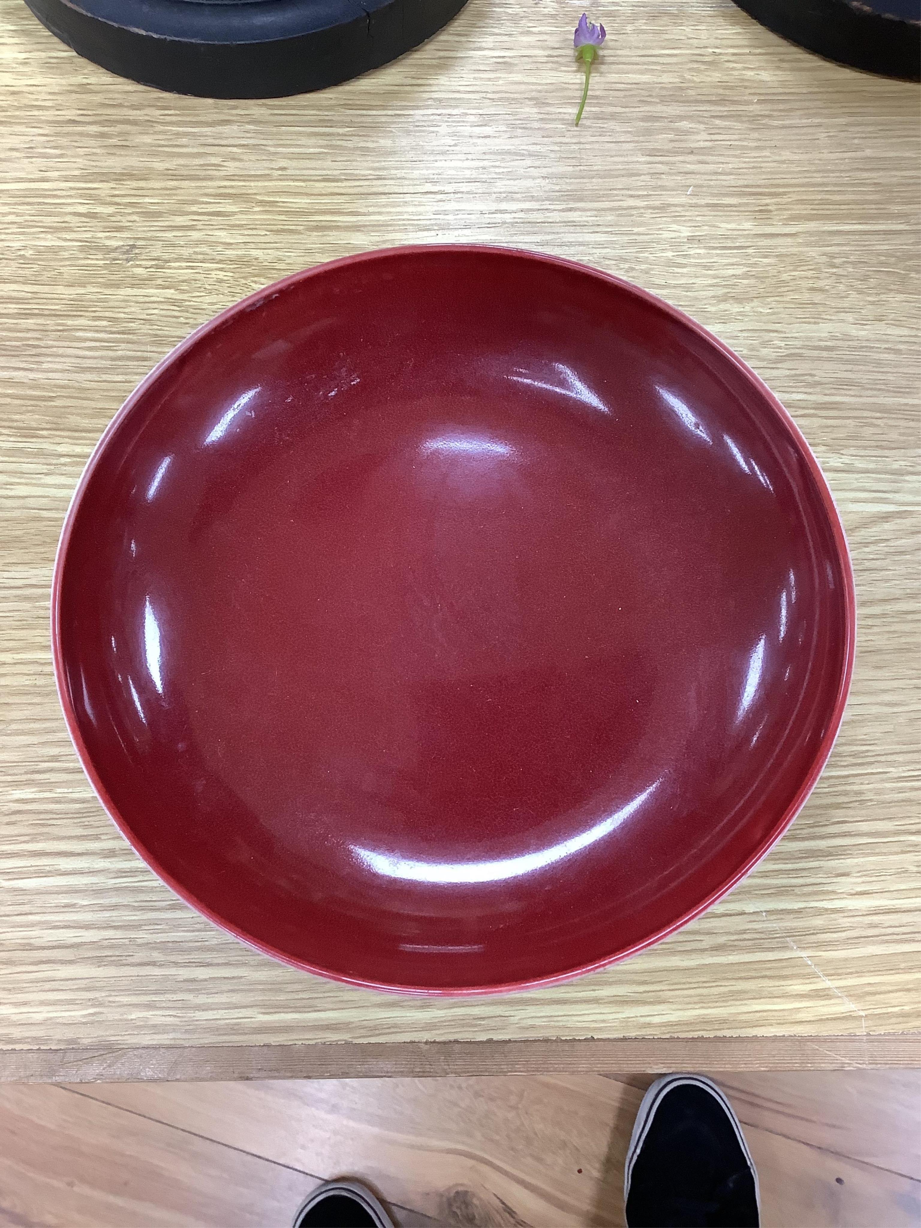 A Chinese copper red glazed dish, a blue and white bowl and a similar dish, bowl 22.5cm diameter. Condition - good